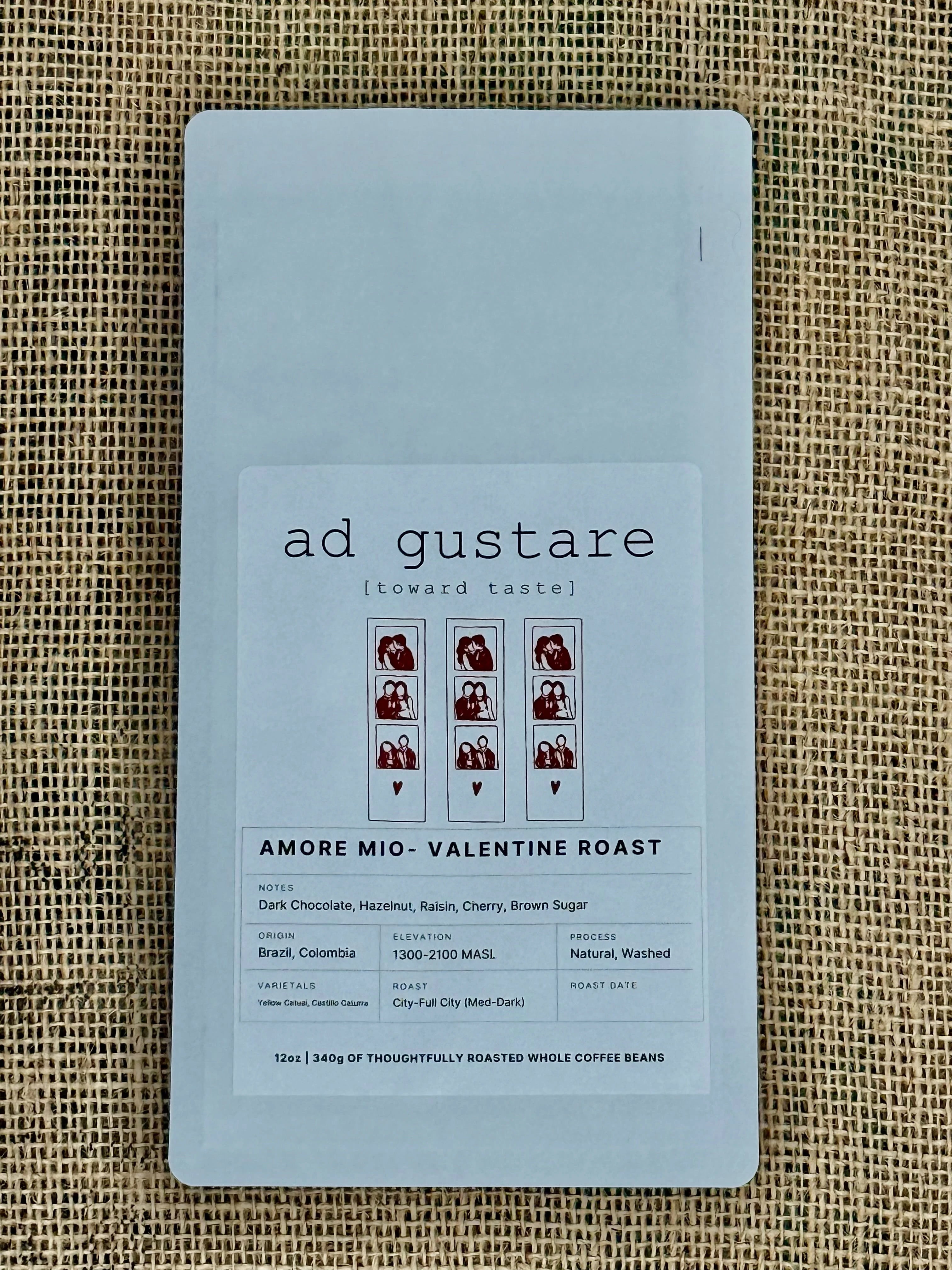 Coffee package labeled 'ad gustare' on a textured fabric background